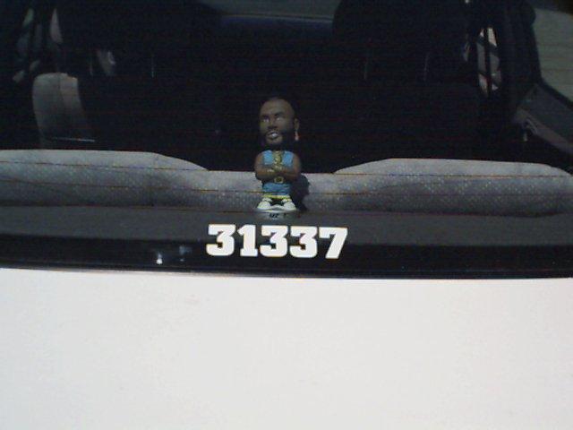Dashboard bobblehead with "31337" plate