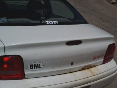 1995 Plymouth Neon - Rear view of a white sedan with a BNL sticker and a numerical sticker on the trunk.
