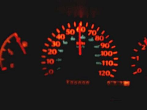 1995 Plymouth Neon - The illuminated dashboard gauges show the vehicle's speed and mileage.