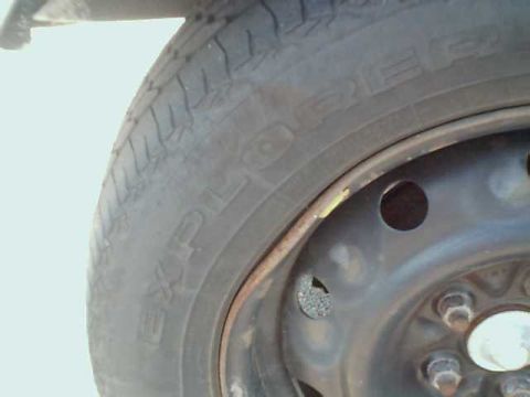 1995 Plymouth Neon - Close-up of a tire and wheel assembly, showing tread detail and the steel rim.