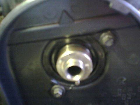 1995 Plymouth Neon - This image shows a close-up of a bolt head within a black housing, likely an engine component.