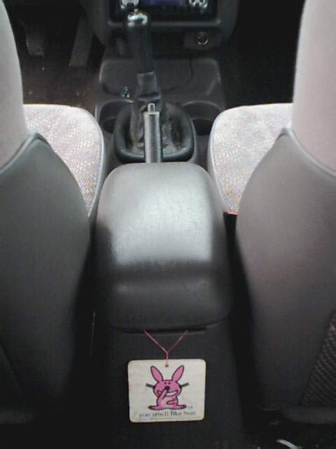 1995 Plymouth Neon - The interior of a vehicle is shown, focusing on the center console and a bunny-themed air freshener.