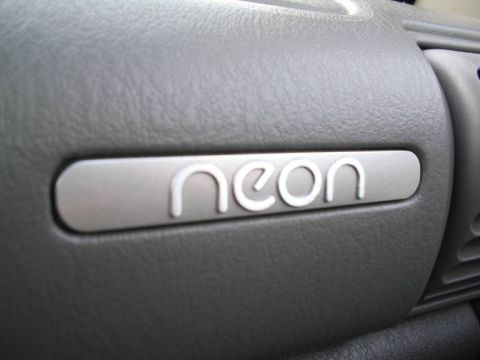 1995 Plymouth Neon - Close-up of a "neon" badge on a car's interior dashboard trim.