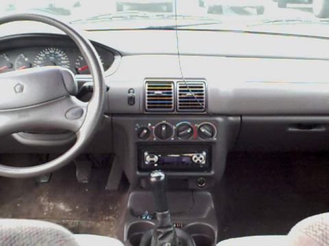 1995 Plymouth Neon - Dashboard view of a 1995 Plymouth Neon, showing the steering wheel, instrument cluster, and radio.