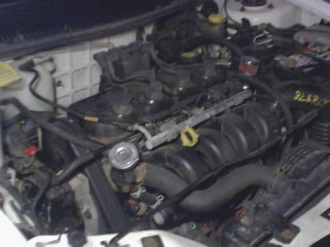 1995 Plymouth Neon - Close-up view of a car's engine bay, showing various mechanical parts and wiring.