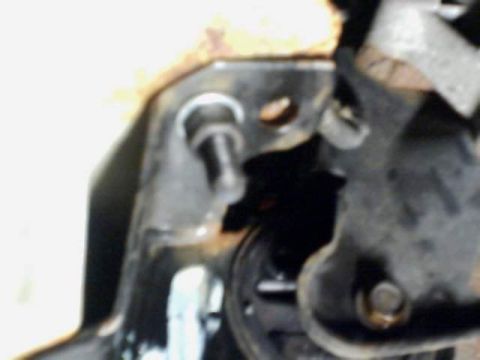 1995 Plymouth Neon - This image shows a close-up of a rusty metal bracket and bolt, likely a component of a vehicle's suspension system.