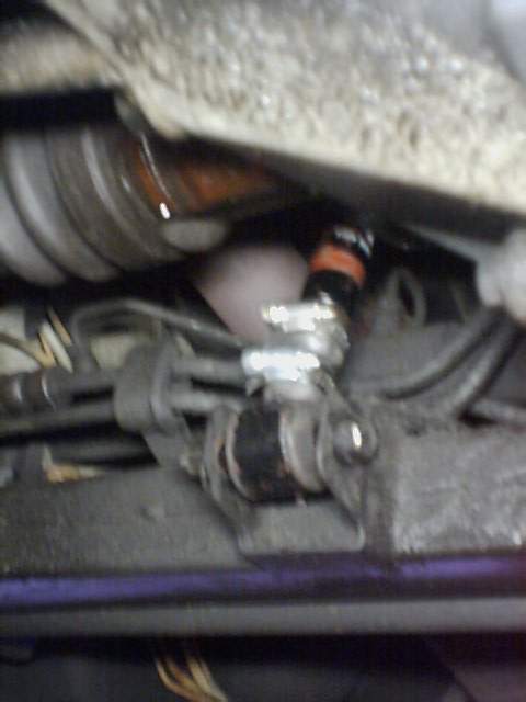 1995 Plymouth Neon - Undercarriage view of a vehicle, focusing on mechanical components and hoses.