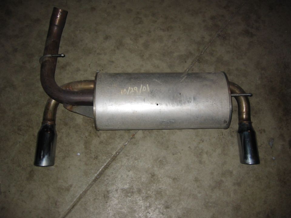 Exhaust muffler with two chrome tips. Date '10/29/01' written on it