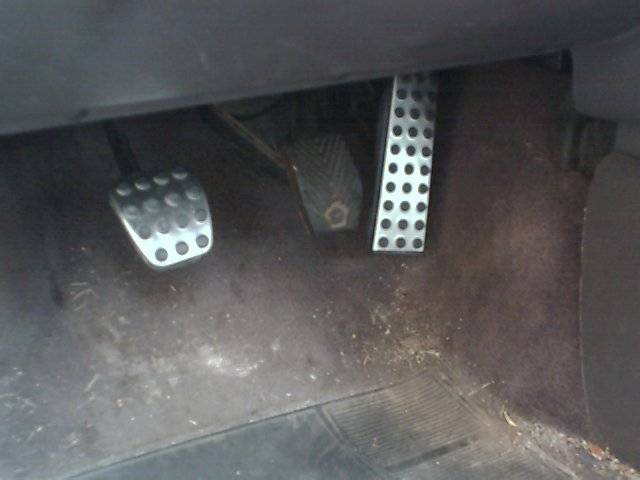 Interior view of three pedals with drilled metal covers