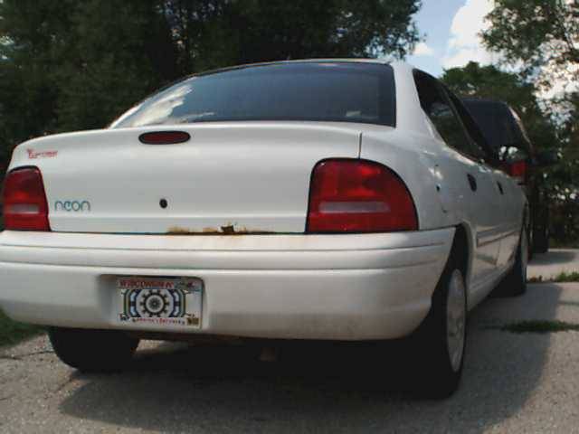 White sedan rear with 'neon' badge and Wisconsin license plate