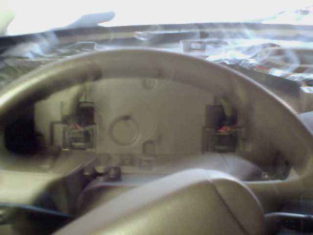 Dashboard wiring harness with connectors and red and black wires visible