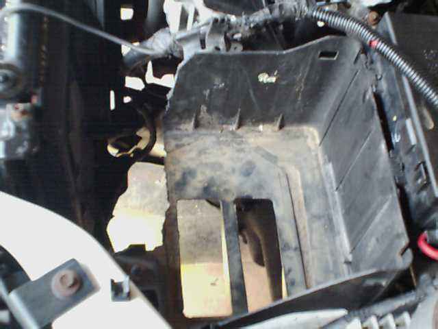 Close-up of an empty car battery tray with wiring visible