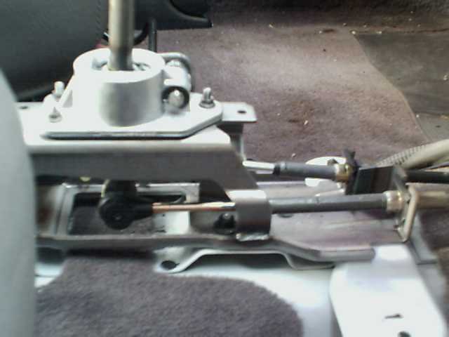 Gear shifter assembly with cables and linkage, viewed from the side