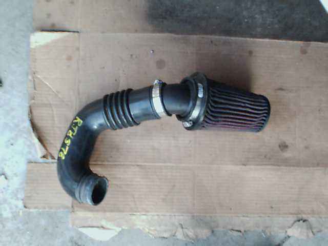 Aftermarket air intake hose with filter. Yellow text reads RTHS76
