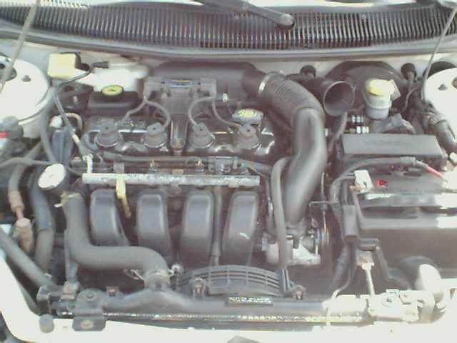 Engine bay with hoses and engine components visible