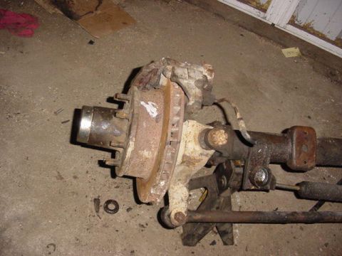 1992 Ford Bronco - Front axle assembly with brake rotor and suspension components, likely for an older truck or SUV.