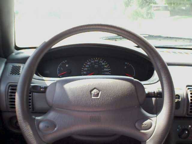 1995 Plymouth Neon interior showing steering wheel and dashboard gauges