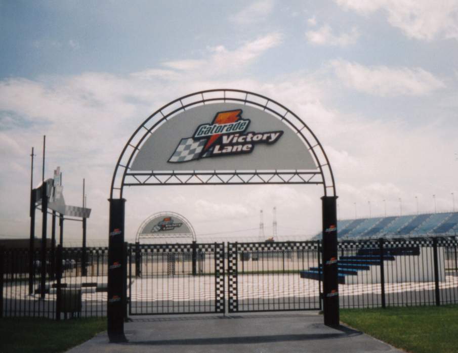 Entrance archway for Gatorade Victory Lane at a racetrack, with grandstands in the background