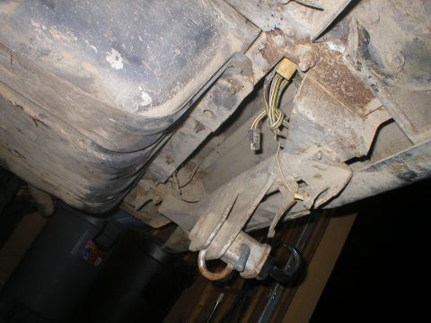 1978 Ford Bronco - Undercarriage view of a 1978 Ford Bronco, showing the fuel tank and trailer hitch assembly.
