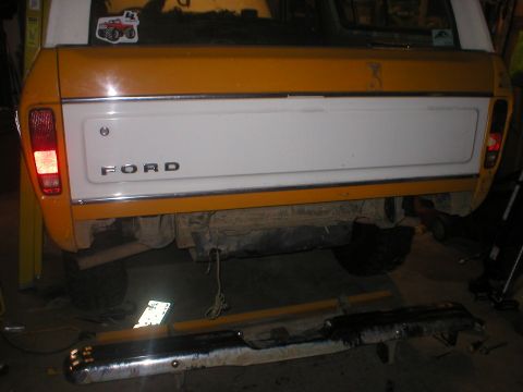 1978 Ford Bronco - The rear of a two-tone yellow and white 1978 Ford Bronco, showing the tailgate and bumper area.