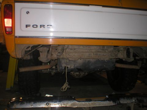 1978 Ford Bronco - Rear view of a 1978 Ford Bronco showing the tailgate, axle, and exhaust system.