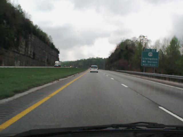 Driving on a highway with a white van ahead and a truck in the distance. Signage indicates exits for Livingston and Mt. Vernon