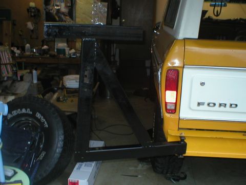 1978 Ford Bronco - Rear view of a 1978 Ford Bronco, its yellow body, white tailgate, and a custom spare tire mount.
