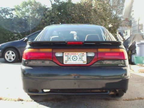 1994 Eagle Talon - Rear view of a 1994 Eagle Talon DL, showing the taillights and spoiler. A second car is visible.