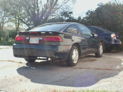 1994 Eagle Talon - Rear view of a dark coupe with a spoiler and a license plate visible.