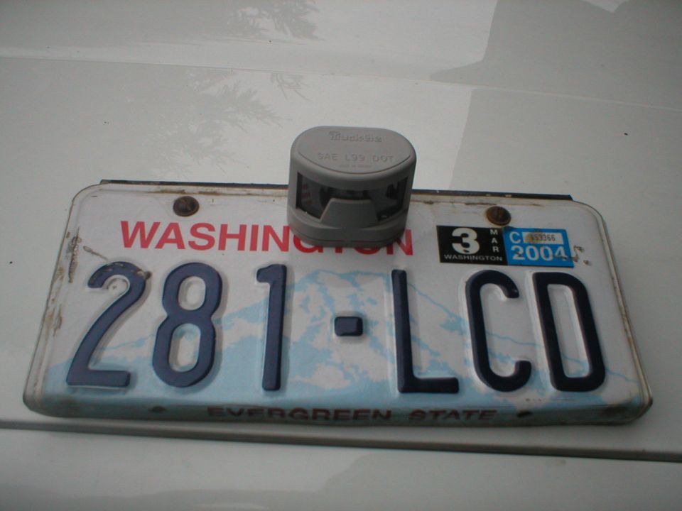 Washington license plate 281-LCD with a gray device on top