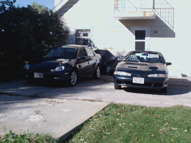 Front view of a dark coupe with a license plate reading 612-CHL
