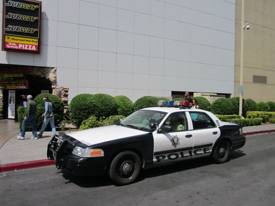 Black and white police car, 2003 Ford Crown Victoria, parked on street, side view