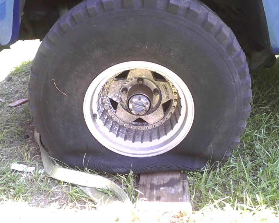 Flat tire on a vehicle, supported by wood blocks