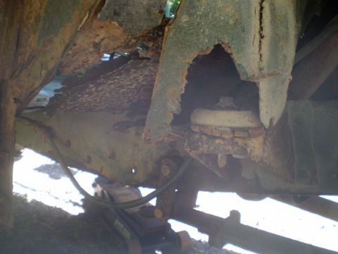 1979 Ford Bronco - The frame and suspension parts are severely corroded, showing significant rust damage.