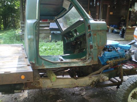 1979 Ford Bronco - This Ford F-Series truck is in a state of disrepair, with its cab stripped down and engine exposed.
