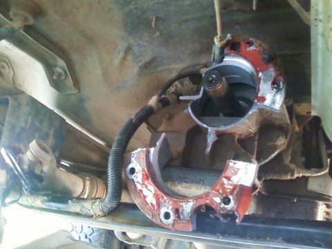 1996 Ford Bronco - Close-up of a broken transmission extension housing, revealing internal components and a driveshaft.