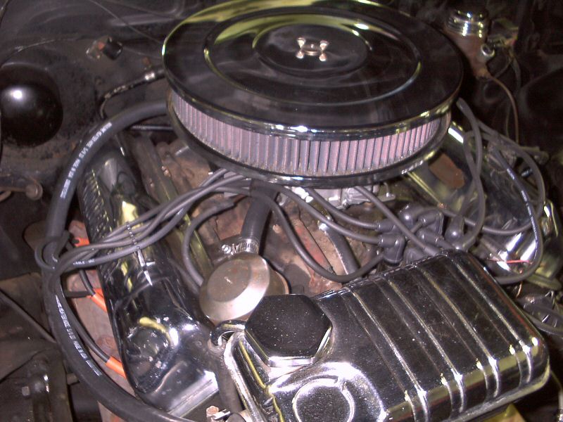 Engine bay with chrome round air cleaner, pleated filter, and gray plug wires