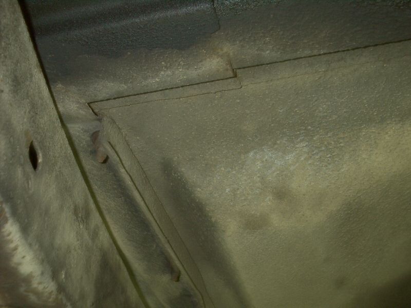 Underbody sheet metal seam with gray primer and welded panels