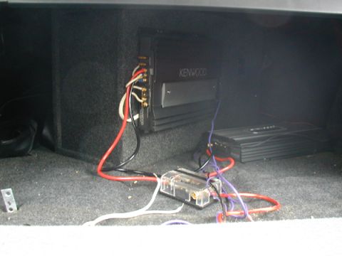 1998 Ford Taurus - Aftermarket car audio amplifiers and wiring are installed in the trunk of a vehicle.