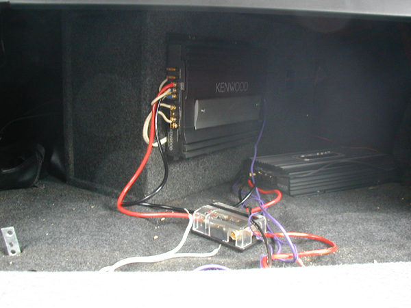 Car audio amplifiers and wiring in trunk, Kenwood amplifier visible
