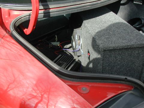 1998 Ford Taurus - Aftermarket audio equipment installed in a car's trunk, including amplifiers and a subwoofer.