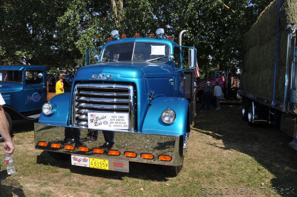 Blue 1951 GMC truck with chrome bumper and grille, parked on grass