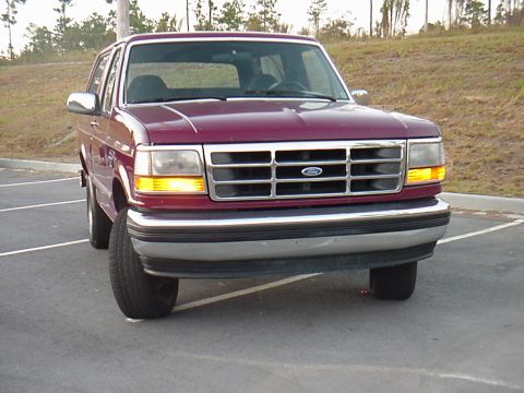 1993 Ford Bronco - This maroon 1993 Ford Bronco is shown from the front in a parking lot.