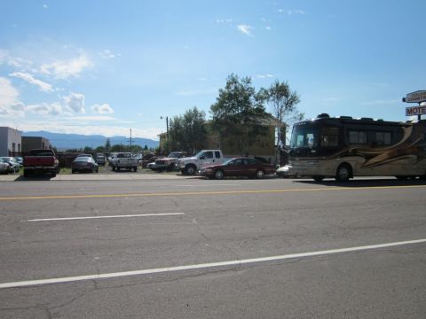 1991 Ford LTD Crown Victoria - A 1991 Ford Crown Victoria sedan is seen parked in a lot with other vehicles, including a large RV and several trucks.