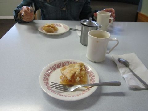 1991 Ford LTD Crown Victoria - A table setting with pie, coffee cups, and cutlery, a Supermotors.net logo in the corner.