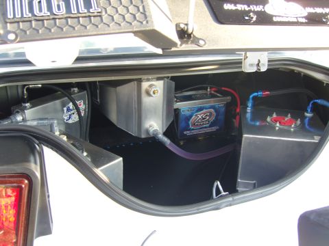 2007 Ford Mustang - Custom modifications in the trunk of a vehicle, including a fuel cell and battery, suggest performance upgrades.