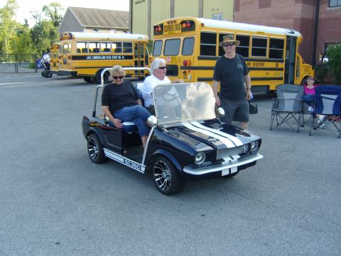 2007 Ford Mustang - Golf cart modified to resemble a 1967 Ford Mustang GT350 is seen at an outdoor event.