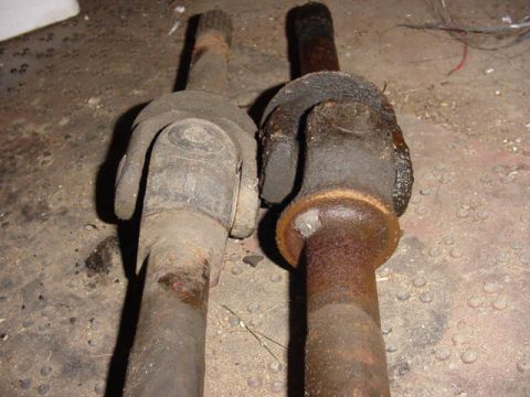 1992 Ford Bronco - Comparison of two driveshaft yokes, one showing significant rust and wear.