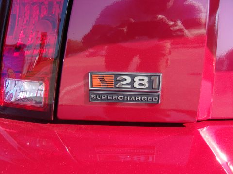 2007 Ford Mustang - Close-up of a red car's rear emblem indicating it is a 281 Supercharged model.