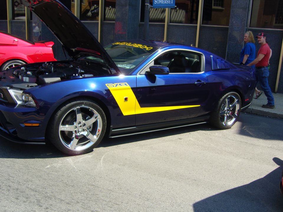 Blue 2007 Ford Mustang with yellow side stripe and ROUSH decal